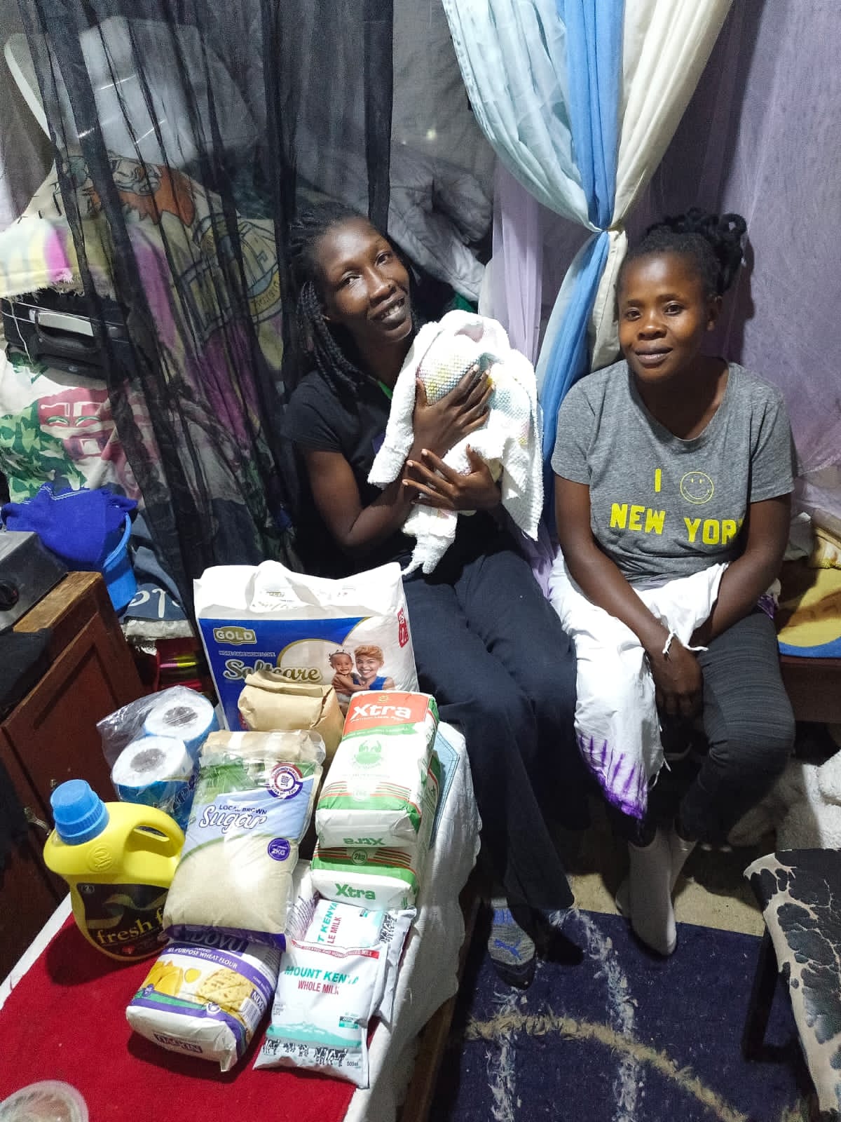 Foundation team visiting a new mother at home with essential supplies