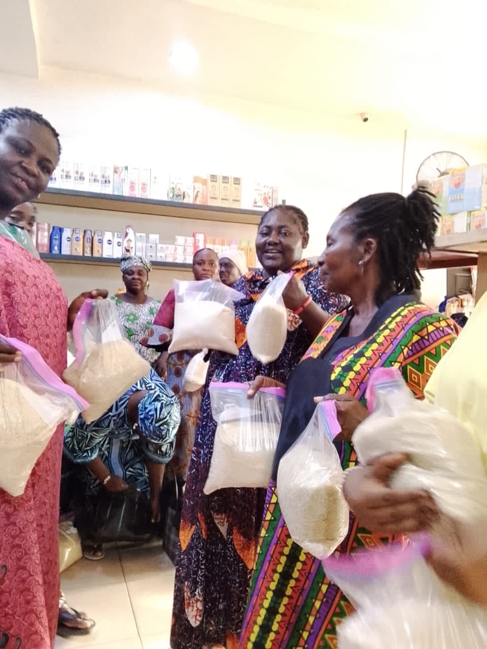 Volunteers distributing bags of rice to community members